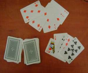 משחק פוקר, 2 ידיים של קלפים פרושות על שולחן עץ חום